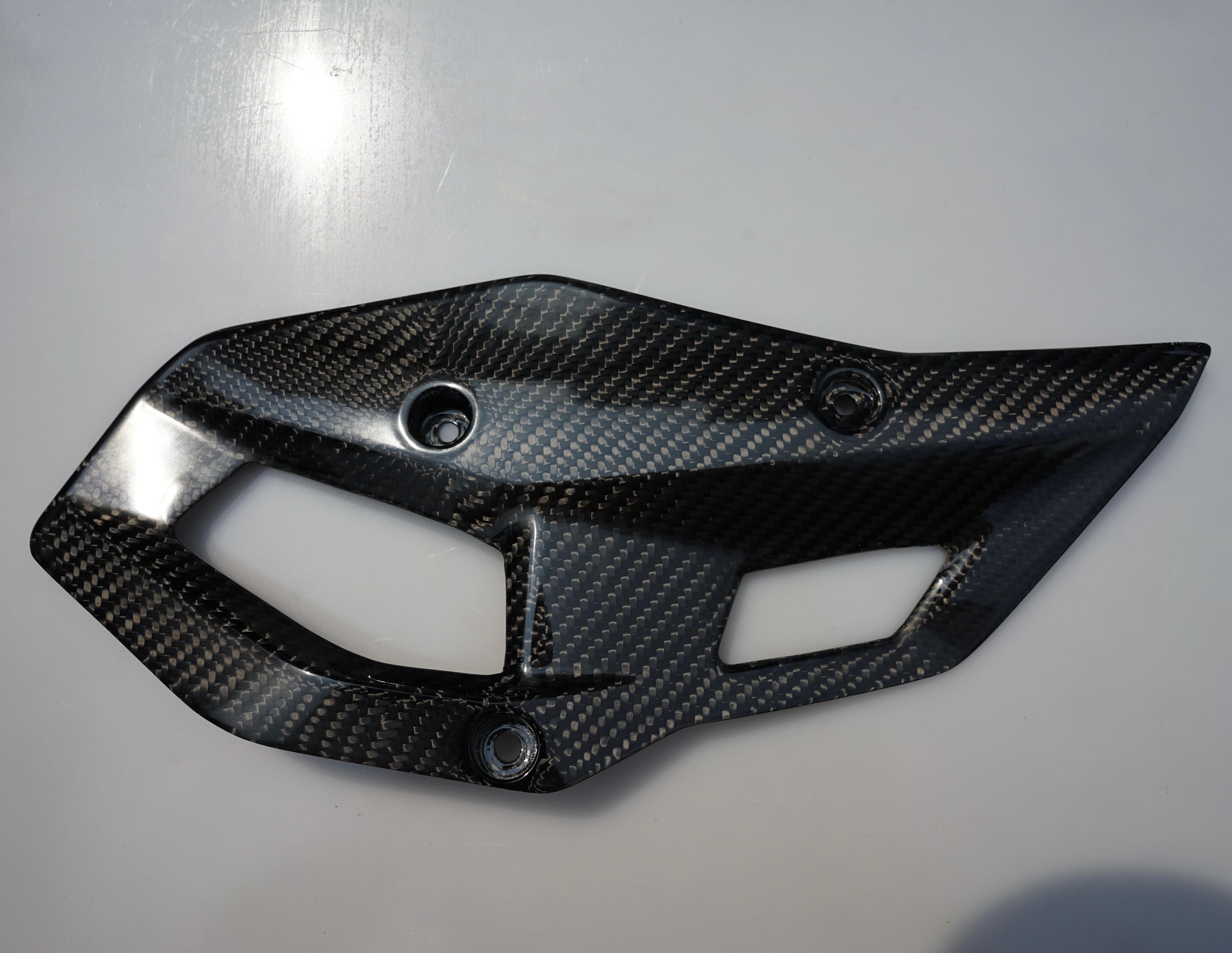 Left-side carbon fiber heel guard for the BMW R 1300 GS motorcycle.