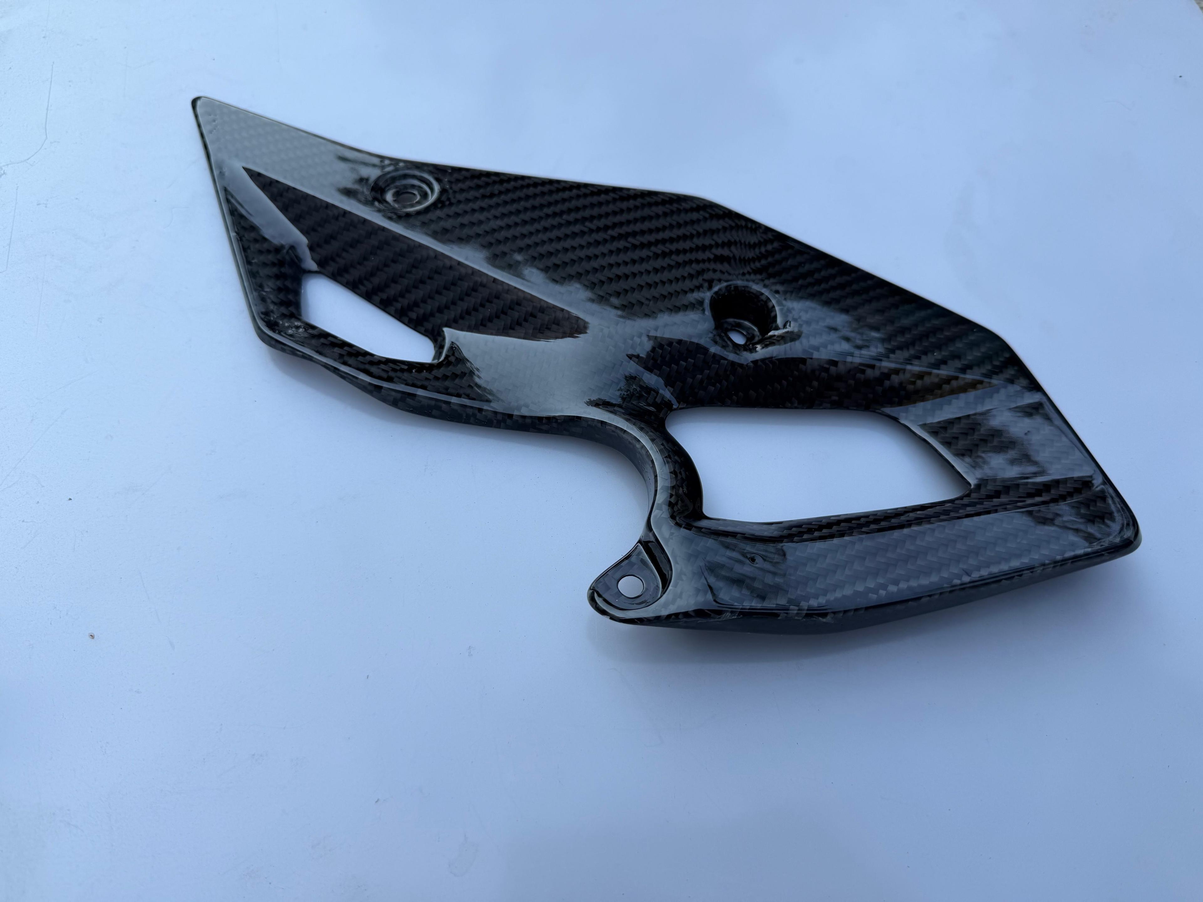 Right-side carbon fiber heel guard for the BMW R 1300 GS motorcycle.