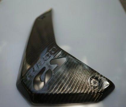BMW R1300GS carbon fiber air intake side panels for motorcycle protection.
